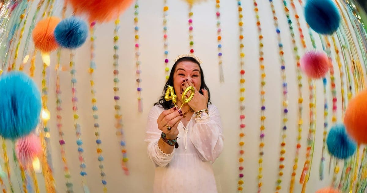 Convidada posando em um cenário de fotos decorado