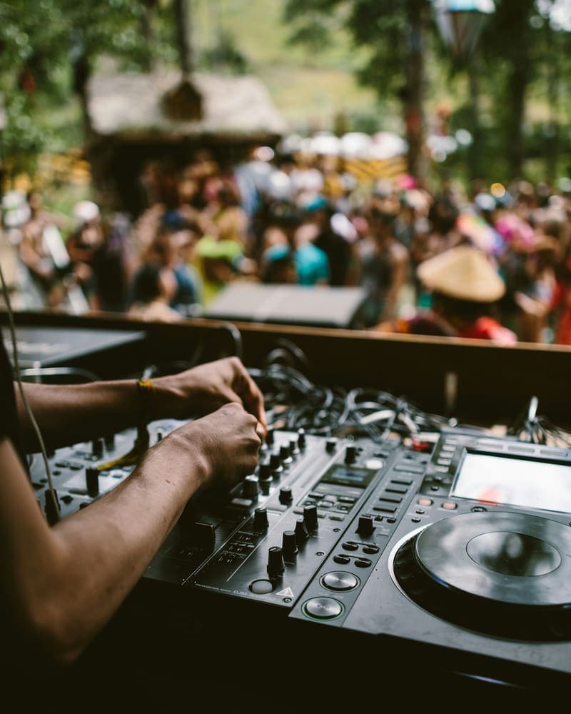 Mãos de DJ mixando na controladora